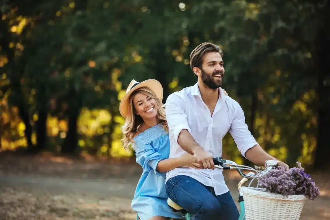 Happy,Young,Couple,Enjoying,Bicycle,Ride,Together