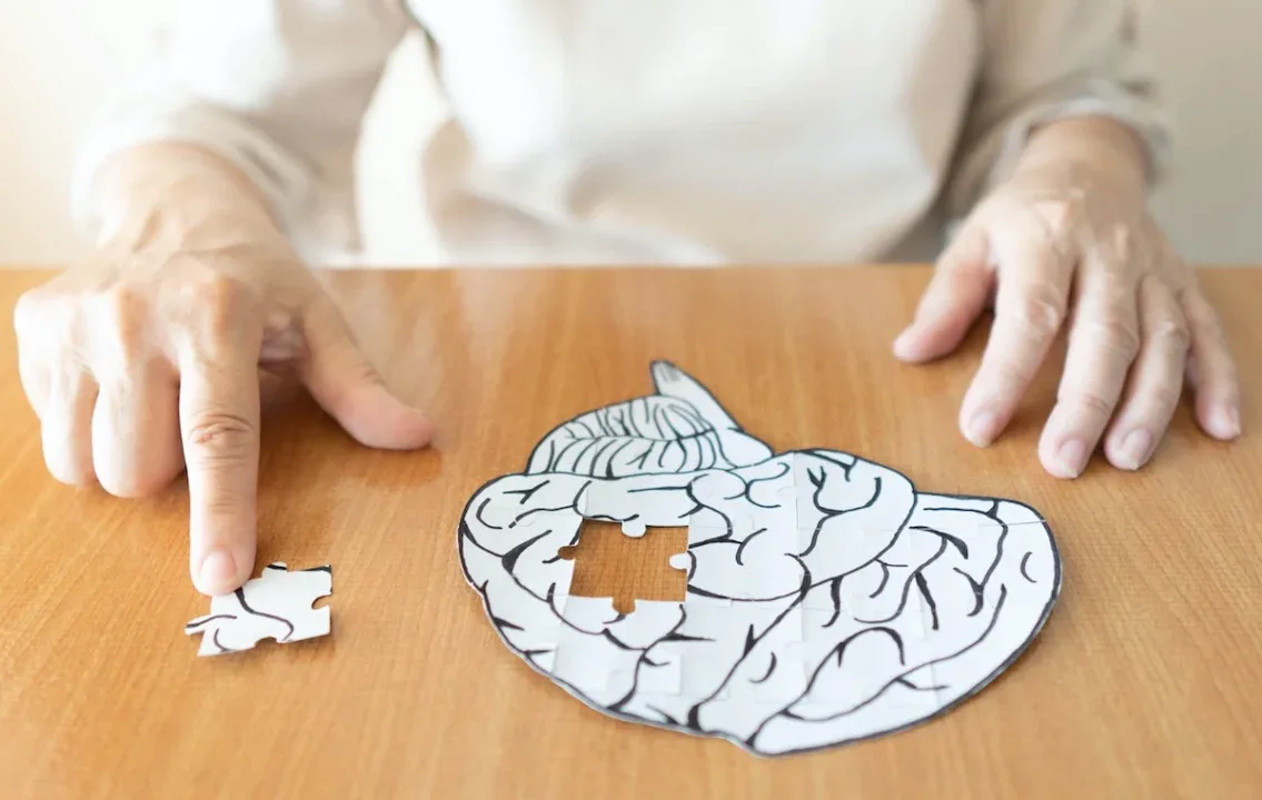 Elderly,Woman,Hands,Putting,Missing,White,Jigsaw,Puzzle,Piece,Down