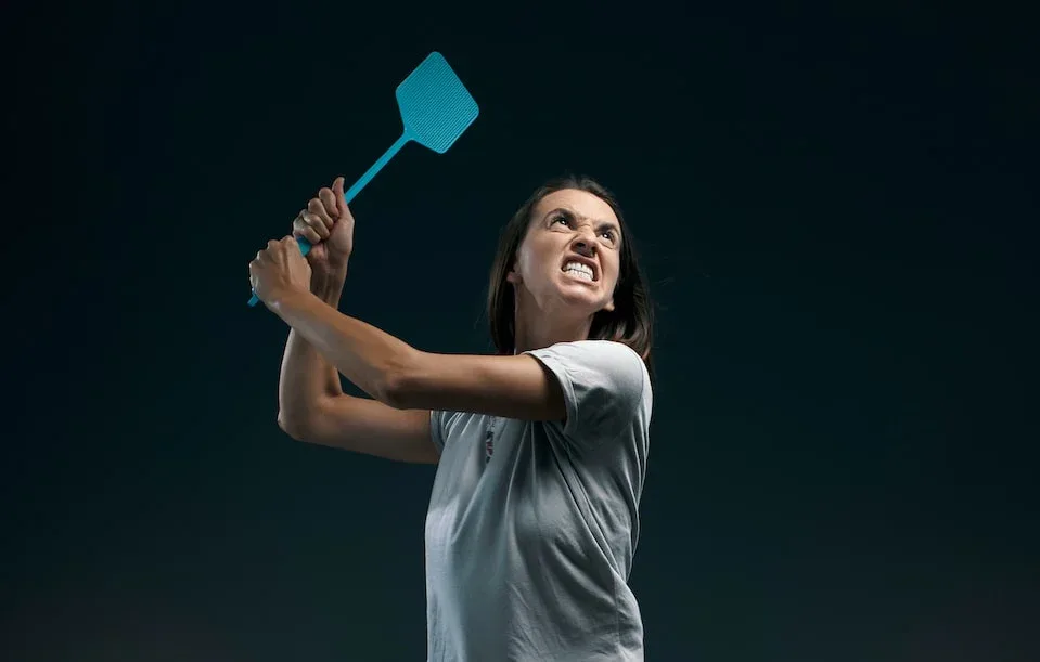 Angry,Woman,Killing,Mosquitoes,,She,Is,Holding,A,Fly,Swatter